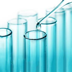 Closeup of test tubes and pipette testing water quality